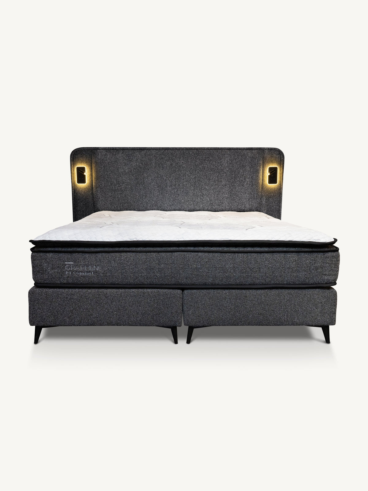 A modern platform bed with a dark gray upholstered headboard and footboard, featuring integrated warm LED light panels on either side of the headboard and a white mattress on top, shown against a plain off-white background.
