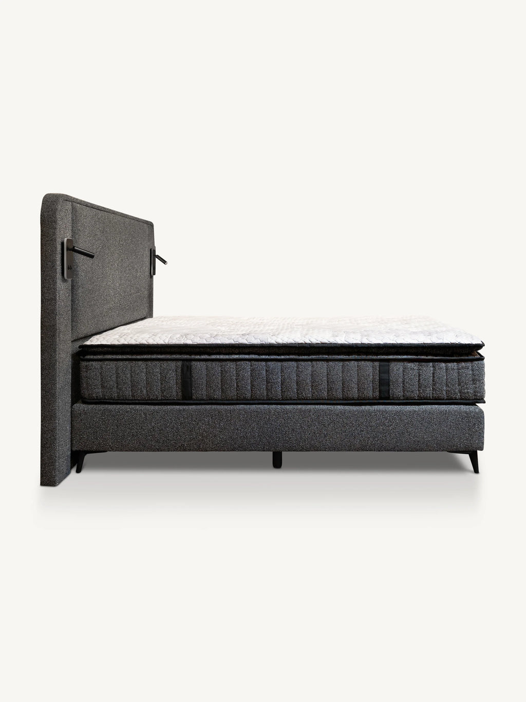 A modern upholstered bed frame with a tall rectangular headboard and a quilted mattress, shown against a plain light background.