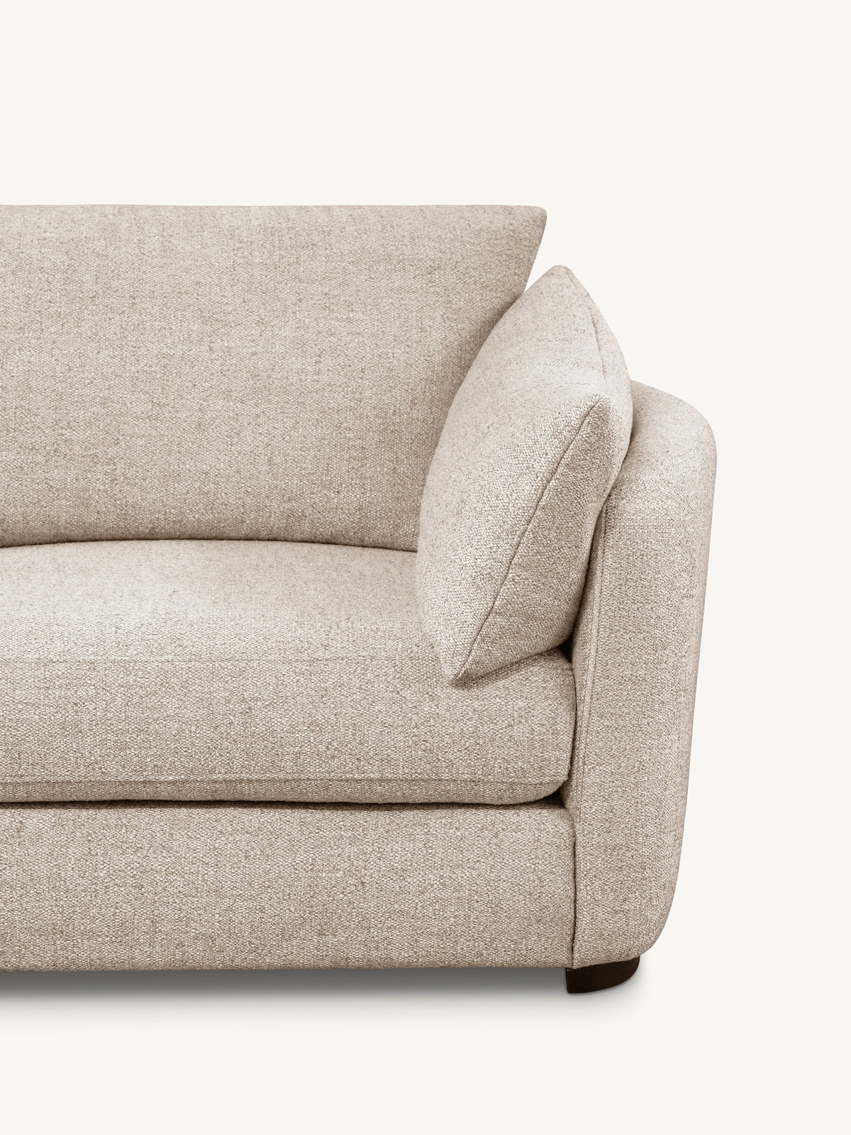 Close-up of a light beige textured fabric sofa showing the armrest, back cushion, and seat cushion against a plain off-white background.