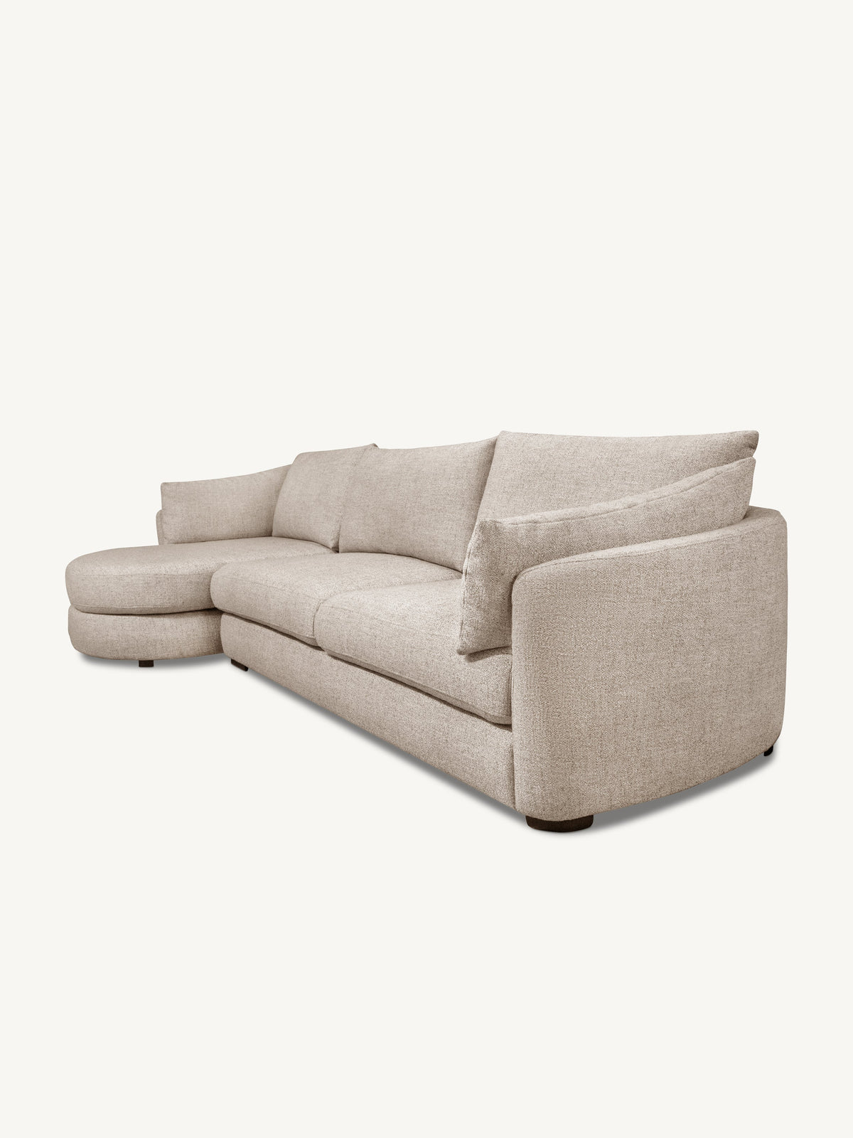 A light beige upholstered sectional sofa with a left-facing chaise lounge, shown from a three-quarter angle against a solid off-white background.