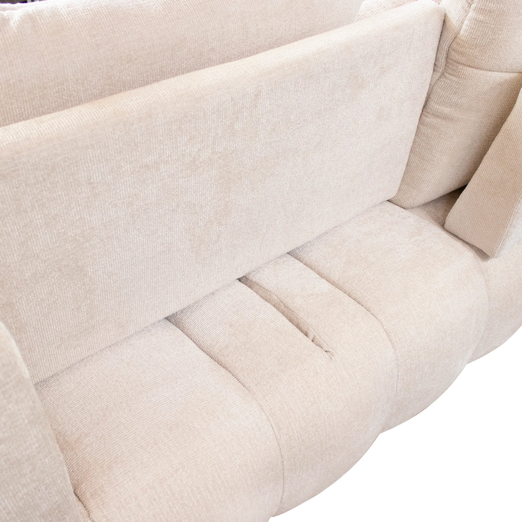 Close-up of a light beige upholstered sofa showing the fabric texture and padded seat and back cushions.