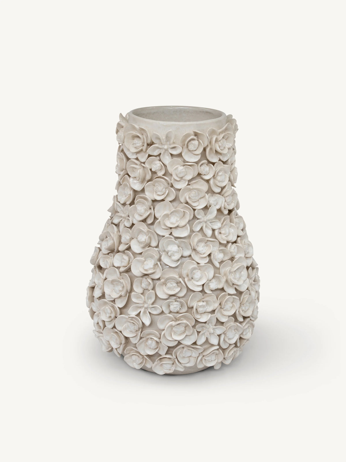 A textured ceramic vase with a flared rim, covered in raised 3D floral rose motifs, in a warm off-white/cream color, set against a solid light gray background.
