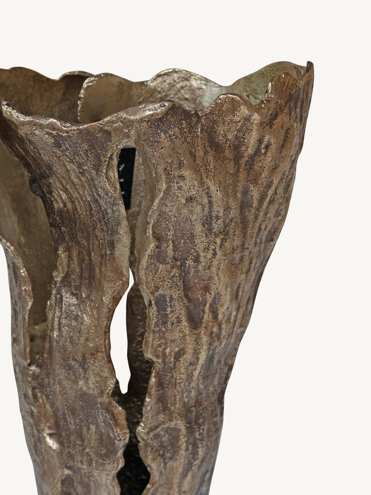 A close-up of a sculptural metallic bronze vase with a textured, bark-like surface and an open, flared rim, shown against a plain off-white background.
